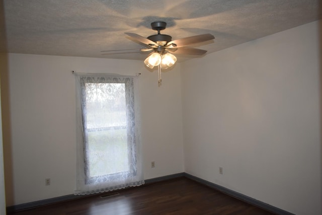 unfurnished room with dark hardwood / wood-style floors and ceiling fan