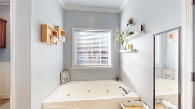 bathroom featuring a washtub and crown molding