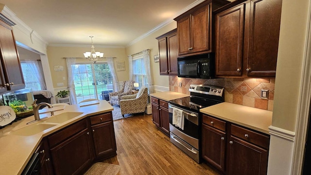 kitchen with ornamental molding, sink, wood-type flooring, a notable chandelier, and stainless steel electric range