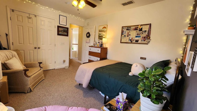 bedroom with ceiling fan, carpet floors, and a closet