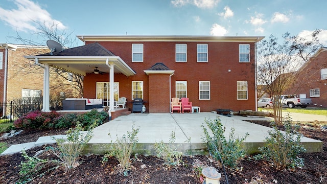 rear view of property with an outdoor living space, ceiling fan, and a patio area