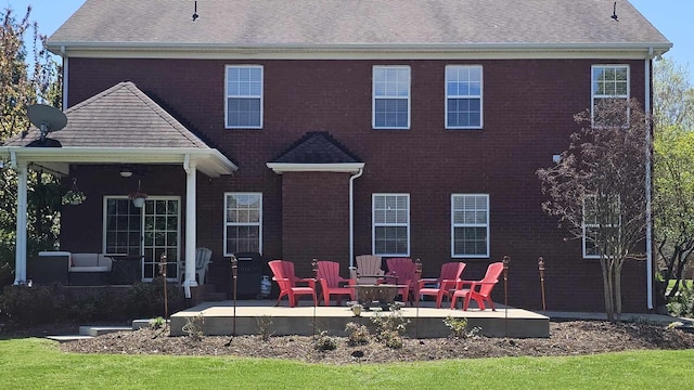 rear view of house with an outdoor fire pit and a patio area