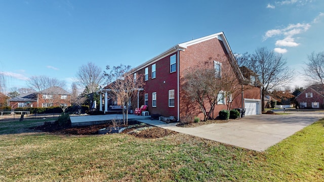 view of side of home featuring a yard and a garage