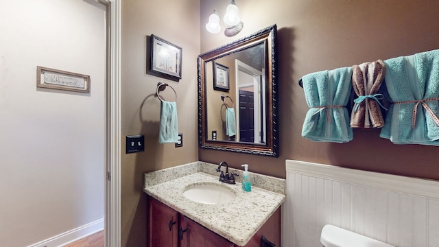 bathroom featuring vanity and toilet