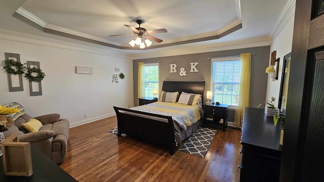 bedroom with a tray ceiling, multiple windows, and ceiling fan