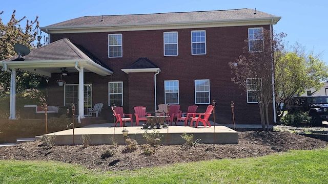 back of property with ceiling fan and a patio