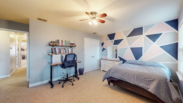 carpeted bedroom with a closet and ceiling fan