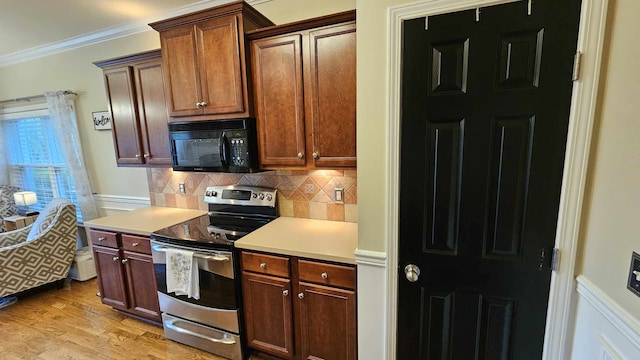 kitchen with backsplash, ornamental molding, stainless steel range with electric cooktop, and light hardwood / wood-style flooring