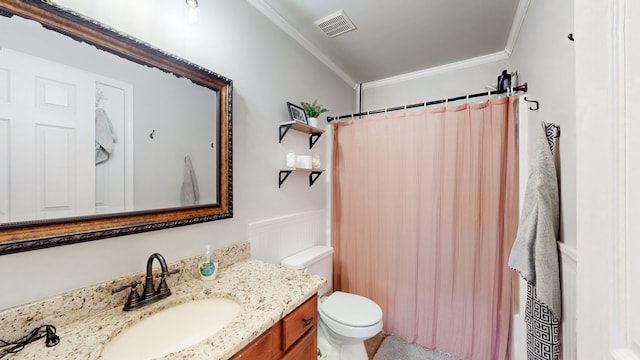 bathroom with vanity, toilet, and crown molding