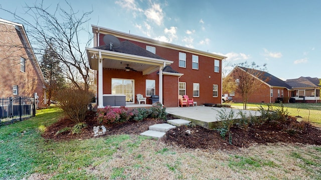 back of property featuring a lawn, ceiling fan, and a patio