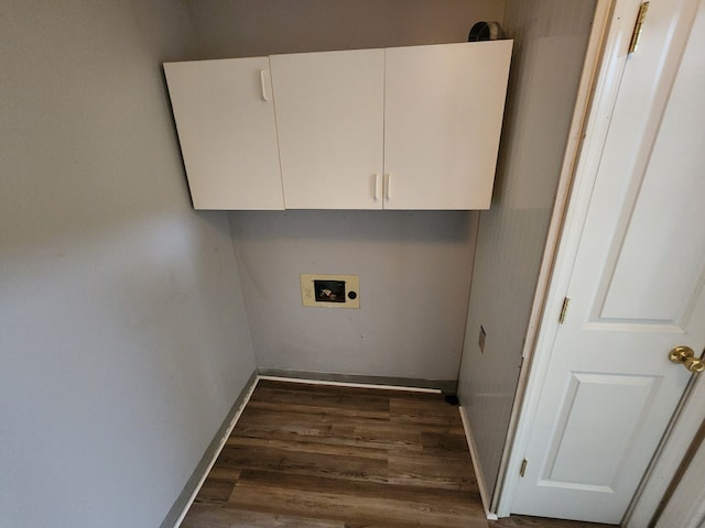 clothes washing area with cabinets, dark hardwood / wood-style floors, and washer hookup