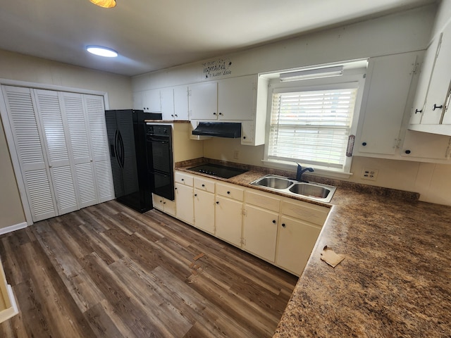 kitchen featuring black appliances, sink, white cabinets, and dark wood-type flooring