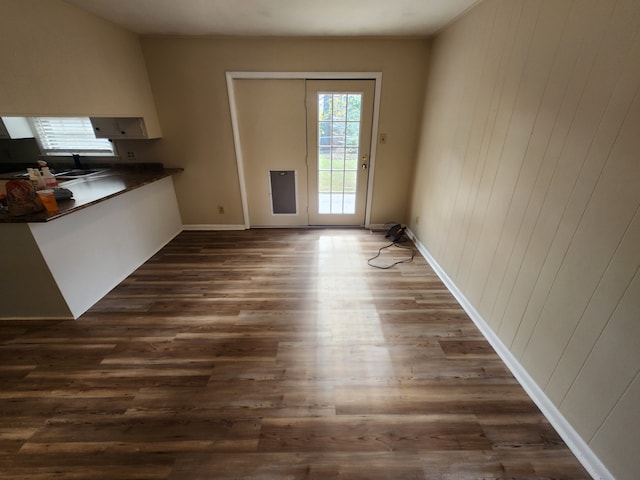 unfurnished dining area featuring dark hardwood / wood-style floors