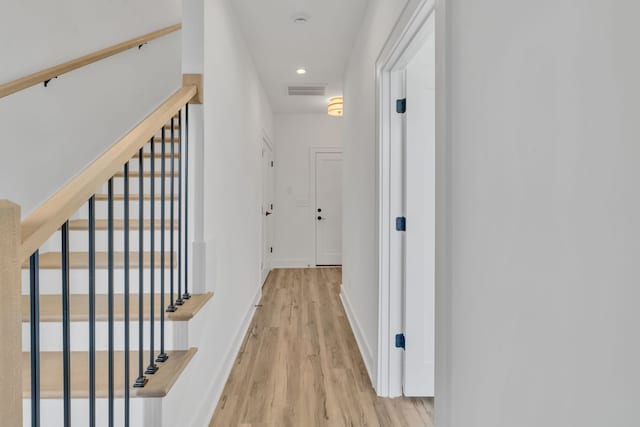 corridor with light hardwood / wood-style floors