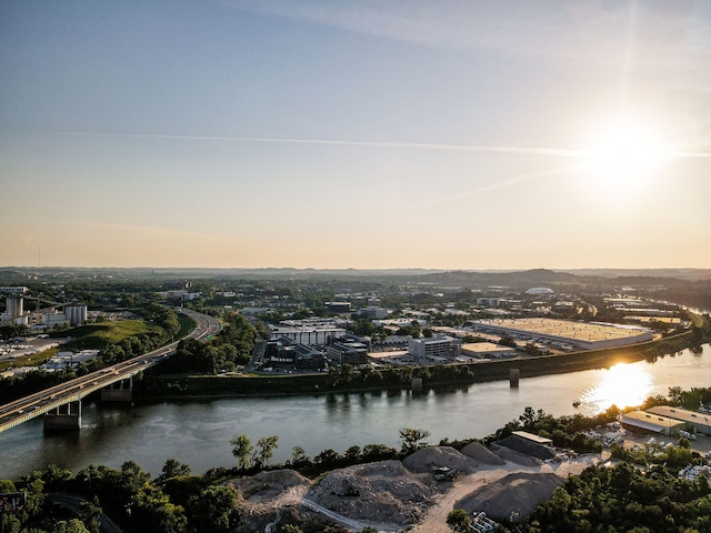 aerial view at dusk featuring a water view