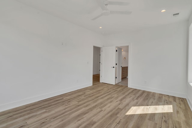 empty room featuring ceiling fan and light hardwood / wood-style flooring