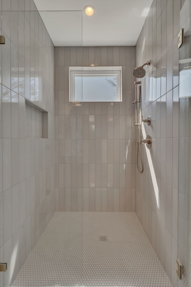 bathroom with a tile shower