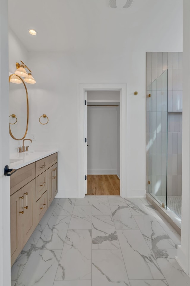 bathroom with vanity and a shower with shower door