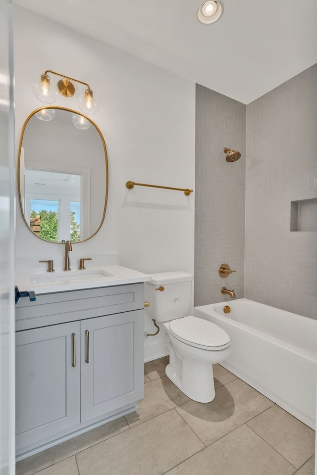 full bathroom with tile patterned flooring, vanity, toilet, and tiled shower / bath