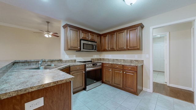 kitchen featuring ceiling fan, sink, stainless steel appliances, kitchen peninsula, and light tile patterned floors