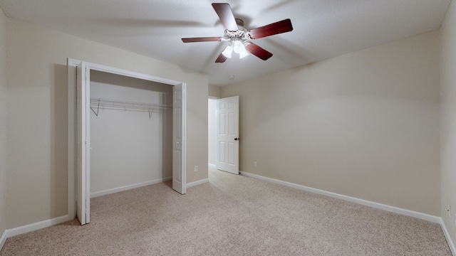 unfurnished bedroom with light carpet, a closet, and ceiling fan