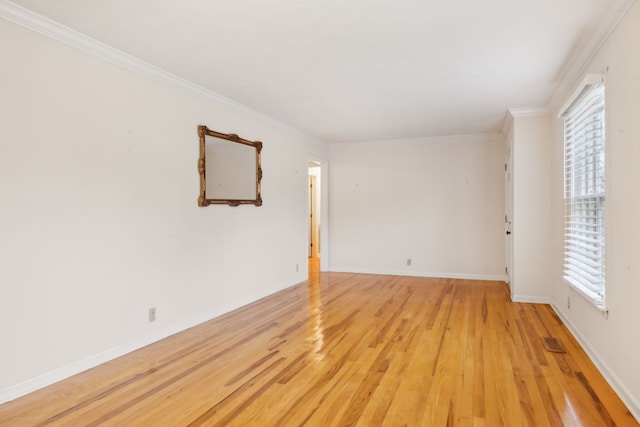 unfurnished room with a healthy amount of sunlight, ornamental molding, and light hardwood / wood-style flooring