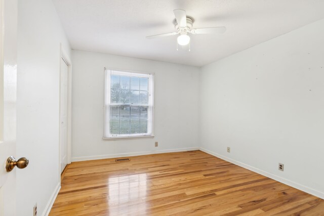 unfurnished room with light wood-type flooring and ceiling fan