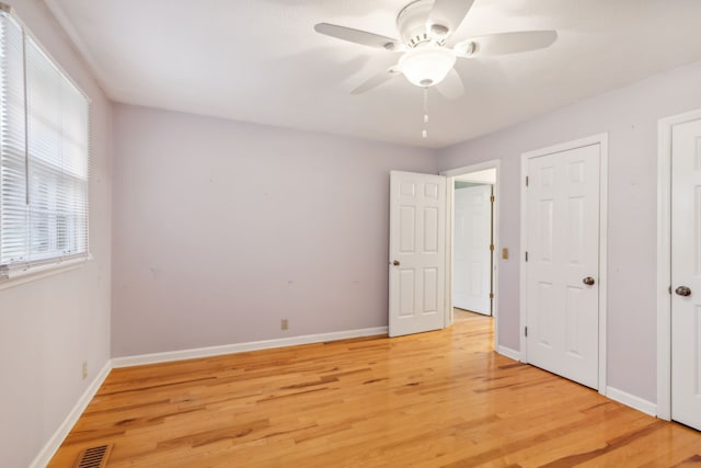 unfurnished bedroom with ceiling fan and light hardwood / wood-style flooring