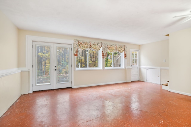 unfurnished room featuring french doors, concrete floors, plenty of natural light, and ceiling fan