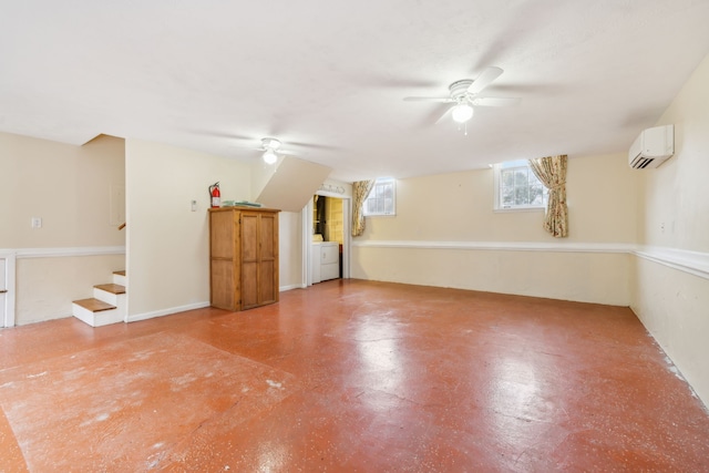 empty room with concrete flooring, washer / dryer, an AC wall unit, and ceiling fan