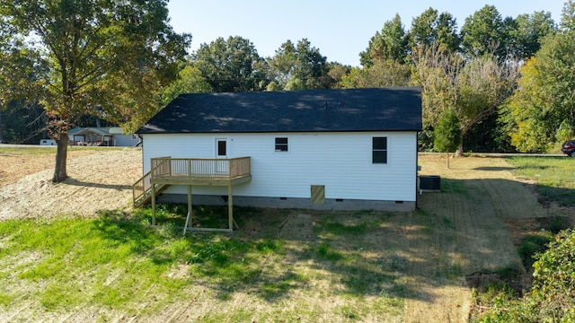 rear view of house with cooling unit, a yard, and a wooden deck