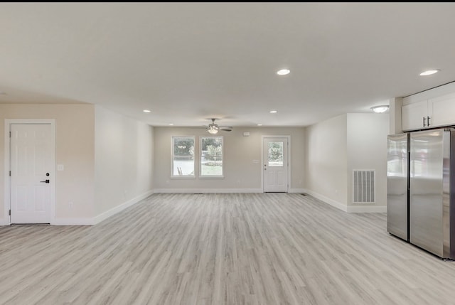 unfurnished living room with ceiling fan and light wood-type flooring