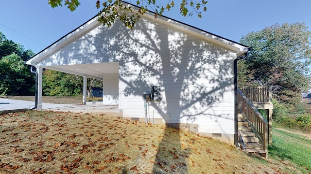 view of side of property with a carport