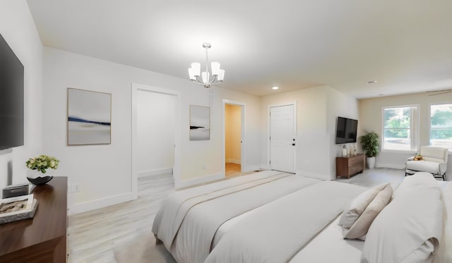 bedroom featuring light hardwood / wood-style floors and a notable chandelier