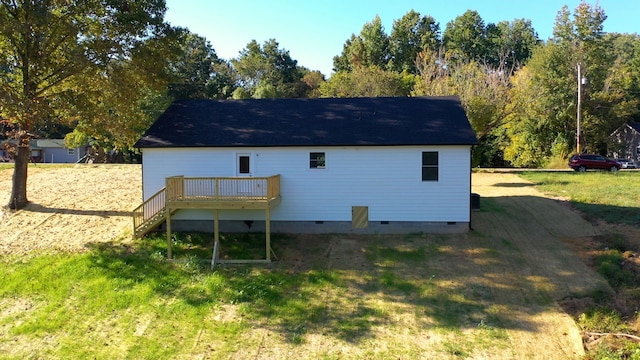 back of house featuring a yard and a deck