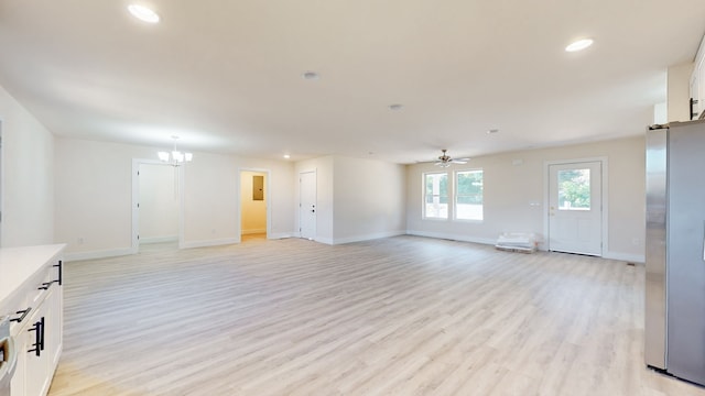 unfurnished living room with light hardwood / wood-style flooring and ceiling fan with notable chandelier