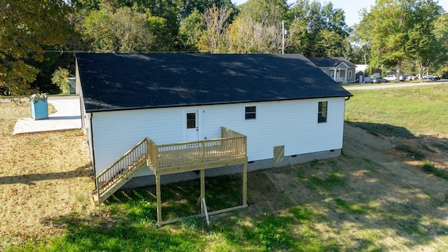 rear view of house with a lawn and a wooden deck