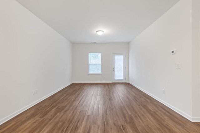 unfurnished room featuring dark hardwood / wood-style floors