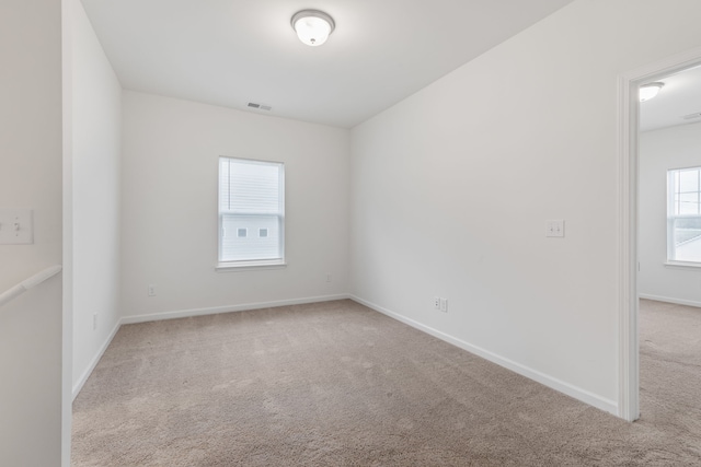 empty room featuring light colored carpet