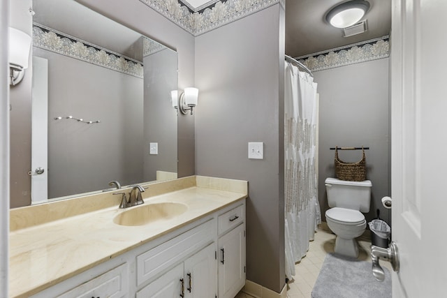 bathroom with tile patterned floors, vanity, and toilet