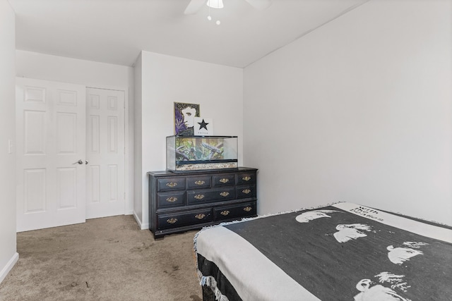 bedroom with carpet, ceiling fan, and a closet