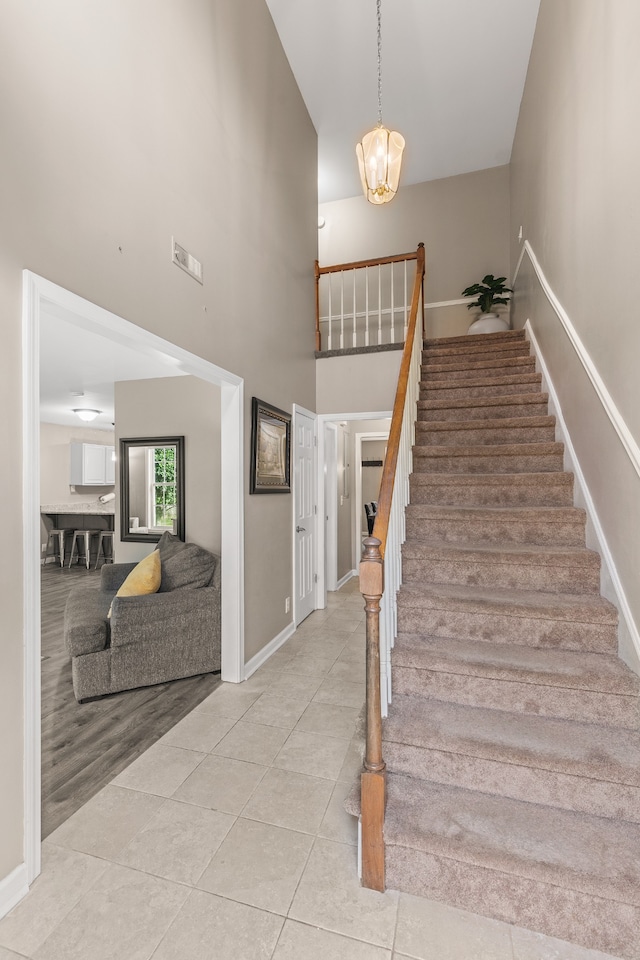 staircase featuring a notable chandelier and hardwood / wood-style flooring