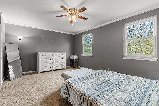 bedroom with multiple windows, ceiling fan, crown molding, and carpet floors