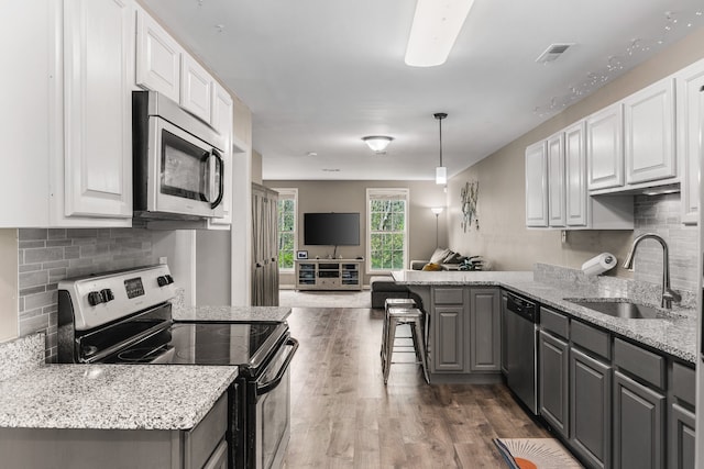 kitchen featuring gray cabinetry, white cabinets, sink, dark hardwood / wood-style floors, and stainless steel appliances