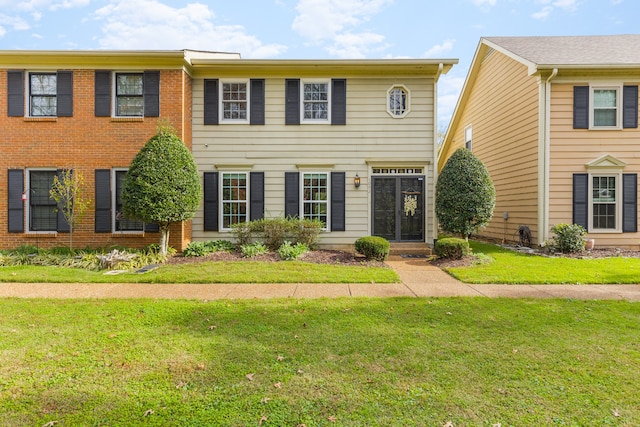 colonial home with a front yard