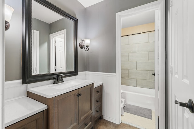 full bathroom featuring tile patterned floors, vanity, tiled shower / bath combo, and toilet