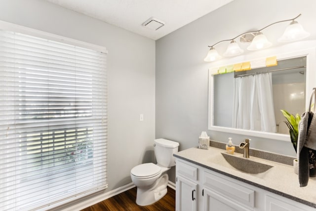 bathroom featuring wood-type flooring, vanity, toilet, and a shower with curtain