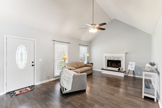 living room with a high end fireplace, dark hardwood / wood-style flooring, high vaulted ceiling, and ceiling fan