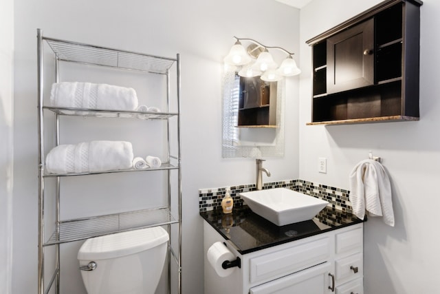 bathroom featuring tasteful backsplash, vanity, and toilet