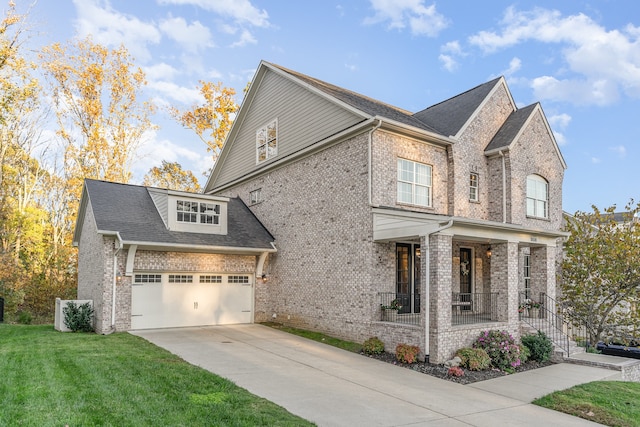 view of side of home featuring covered porch, a yard, and a garage